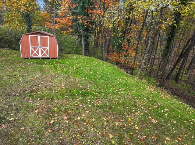 a sign that is sitting in front of a tree