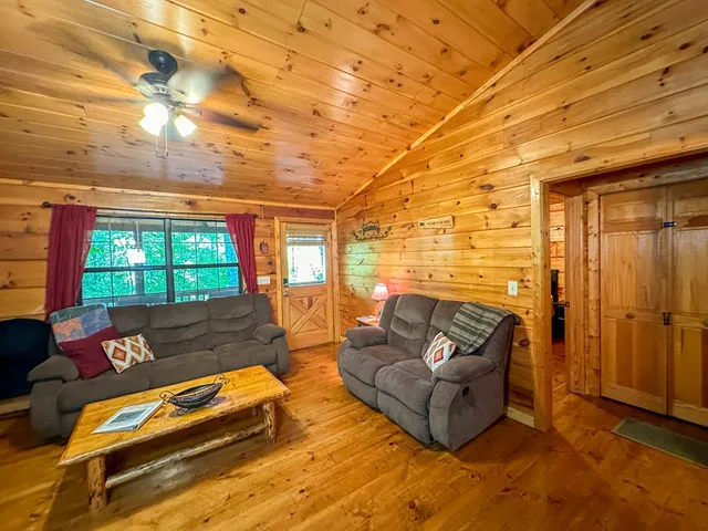 a living room with a bed next to a window