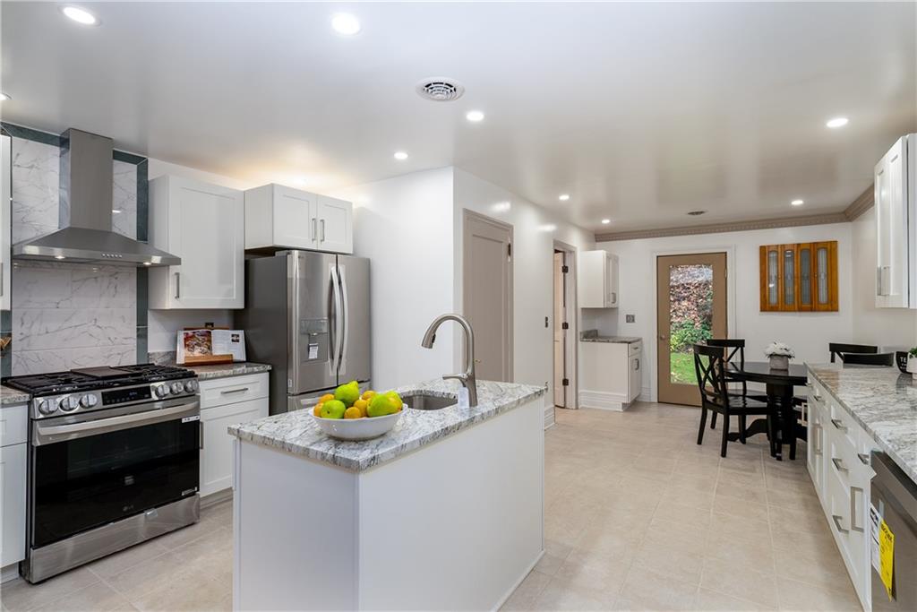 149 Three Degree Road Pittsburgh, PA 15237 - Photo 11 of 50 a kitchen with stainless steel appliances granite countertop a sink stove and refrigerator