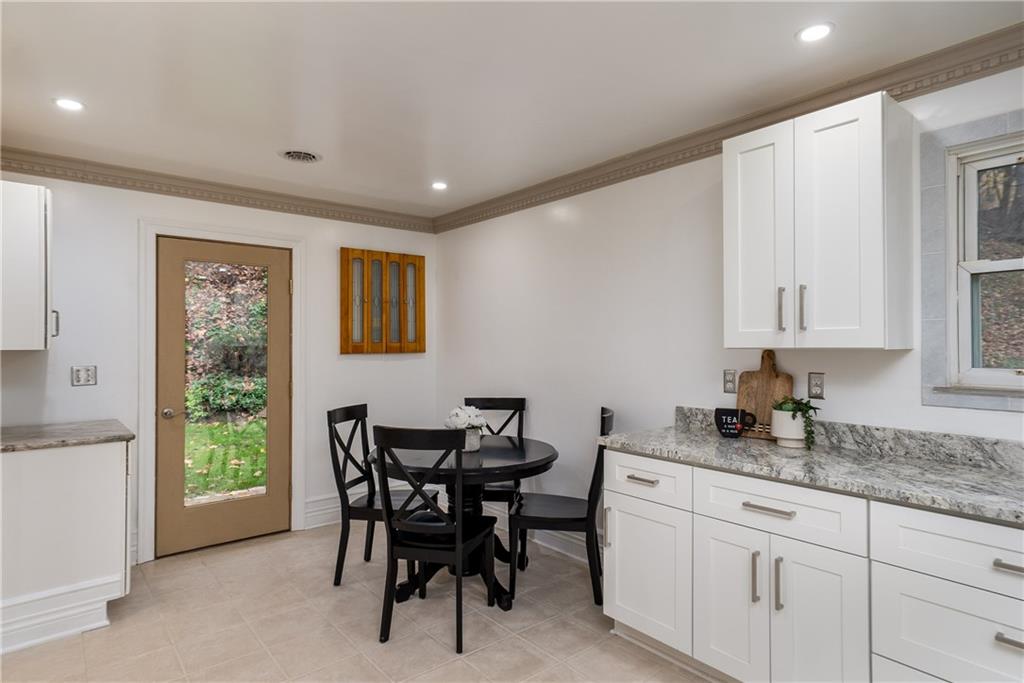 149 Three Degree Road Pittsburgh, PA 15237 - Photo 12 of 50 a kitchen with granite countertop white cabinets dining table and chairs