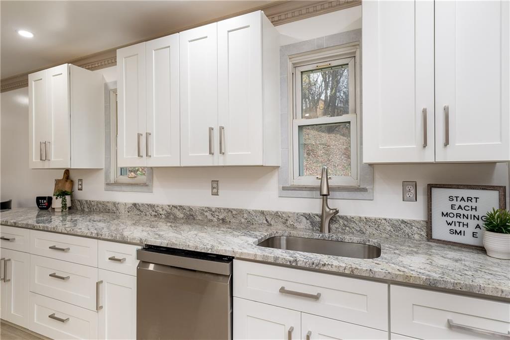 149 Three Degree Road Pittsburgh, PA 15237 - Photo 17 of 50 a kitchen with granite countertop white cabinets white stainless steel appliances a sink and dishwasher with wooden floor