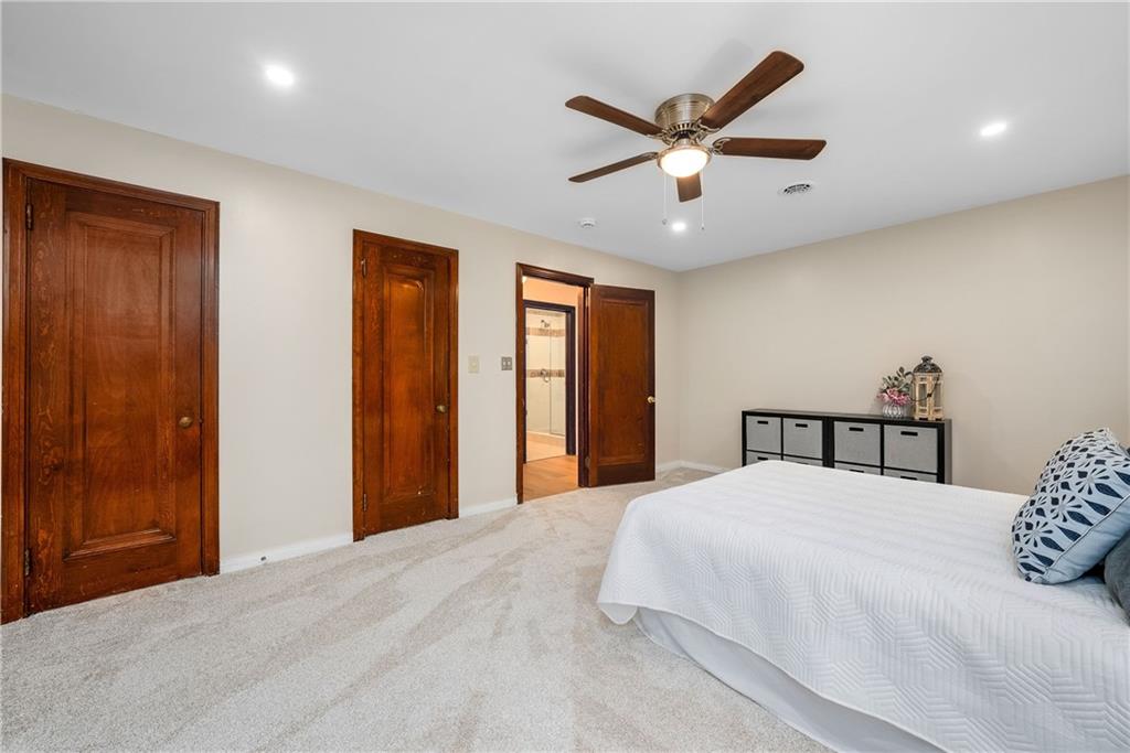 149 Three Degree Road Pittsburgh, PA 15237 - Photo 30 of 50 a bedroom with a large bed and a ceiling fan