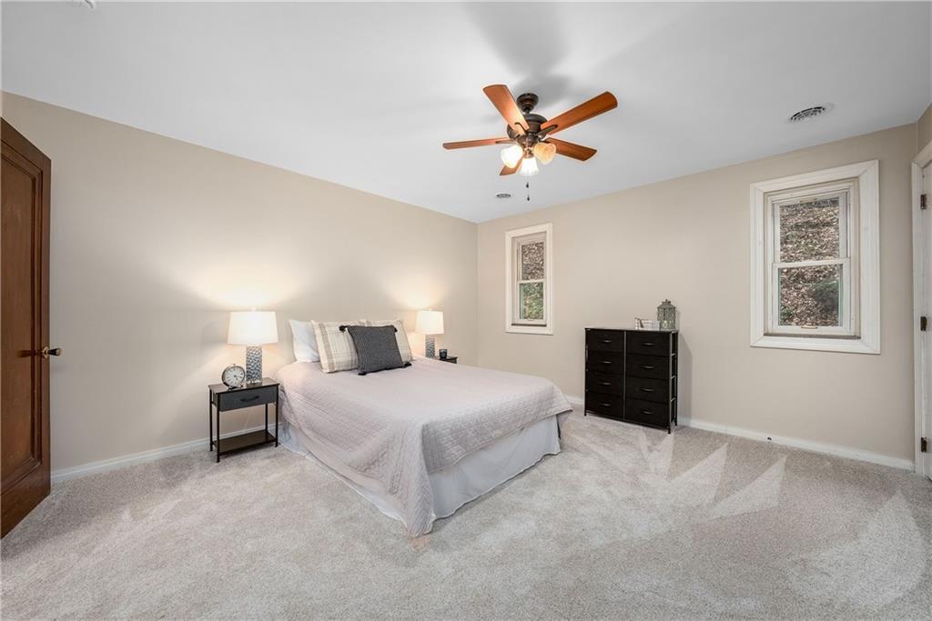 149 Three Degree Road Pittsburgh, PA 15237 - Photo 33 of 50 a bedroom with a bed and a chandelier