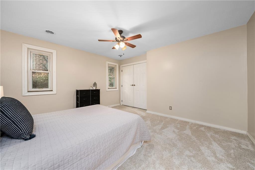 149 Three Degree Road Pittsburgh, PA 15237 - Photo 34 of 50 a spacious bedroom with a bed and a ceiling fan