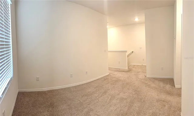 an empty room with a empty space and a window