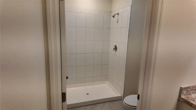 a bathroom with a shower and toilet