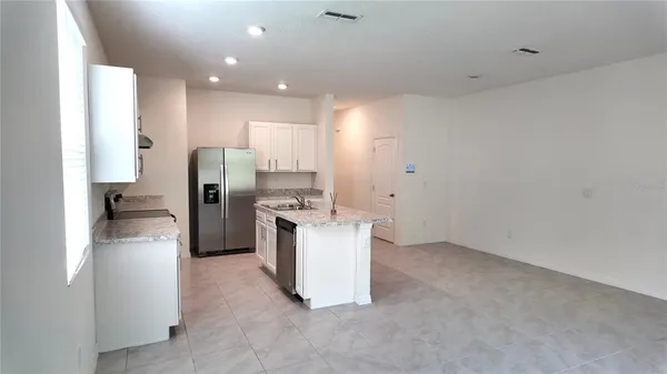 a kitchen with a refrigerator and a sink