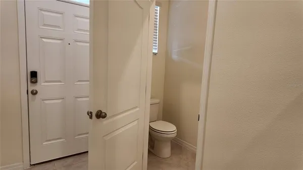 a white toilet sitting next to a shower