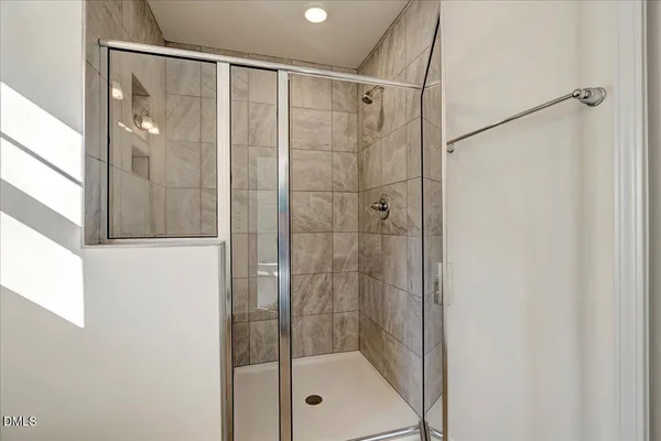 a bathroom with a glass shower door