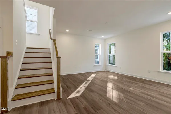 a view of a room with wooden floors and window