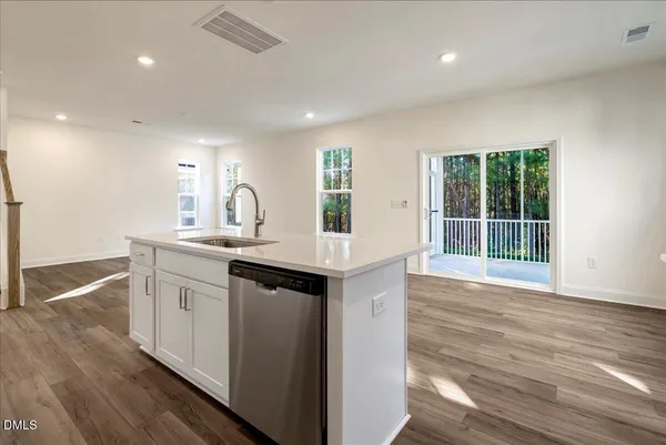 a kitchen with granite countertop a sink and wooden floor