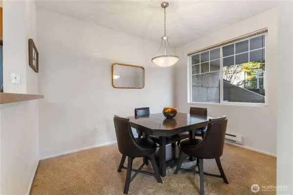 a view of a dining room with a table and chairs
