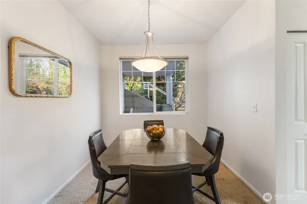 a view of a dining room with a table and chairs