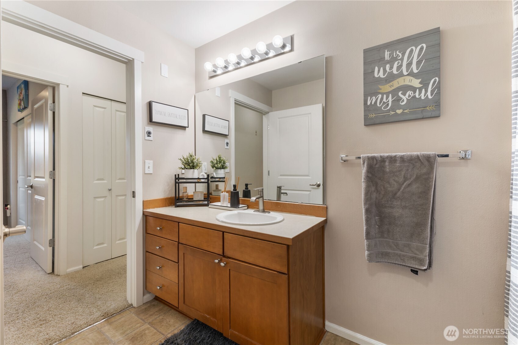 21430 40th Place South, Unit A Seattle, WA 98198 - Photo 17 of 27 a bathroom with a sink and a mirror