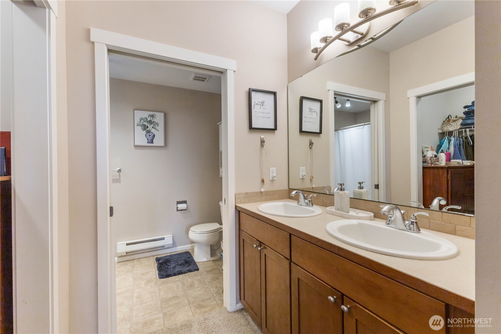 21430 40th Place South, Unit A Seattle, WA 98198 - Photo 20 of 27 a bathroom with a sink double vanity and a toilet