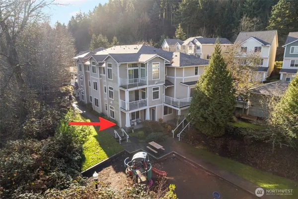 an aerial view of residential houses with outdoor space and ocean view