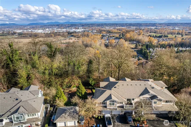an aerial view of a house with a yard swimming pool and outdoor seating