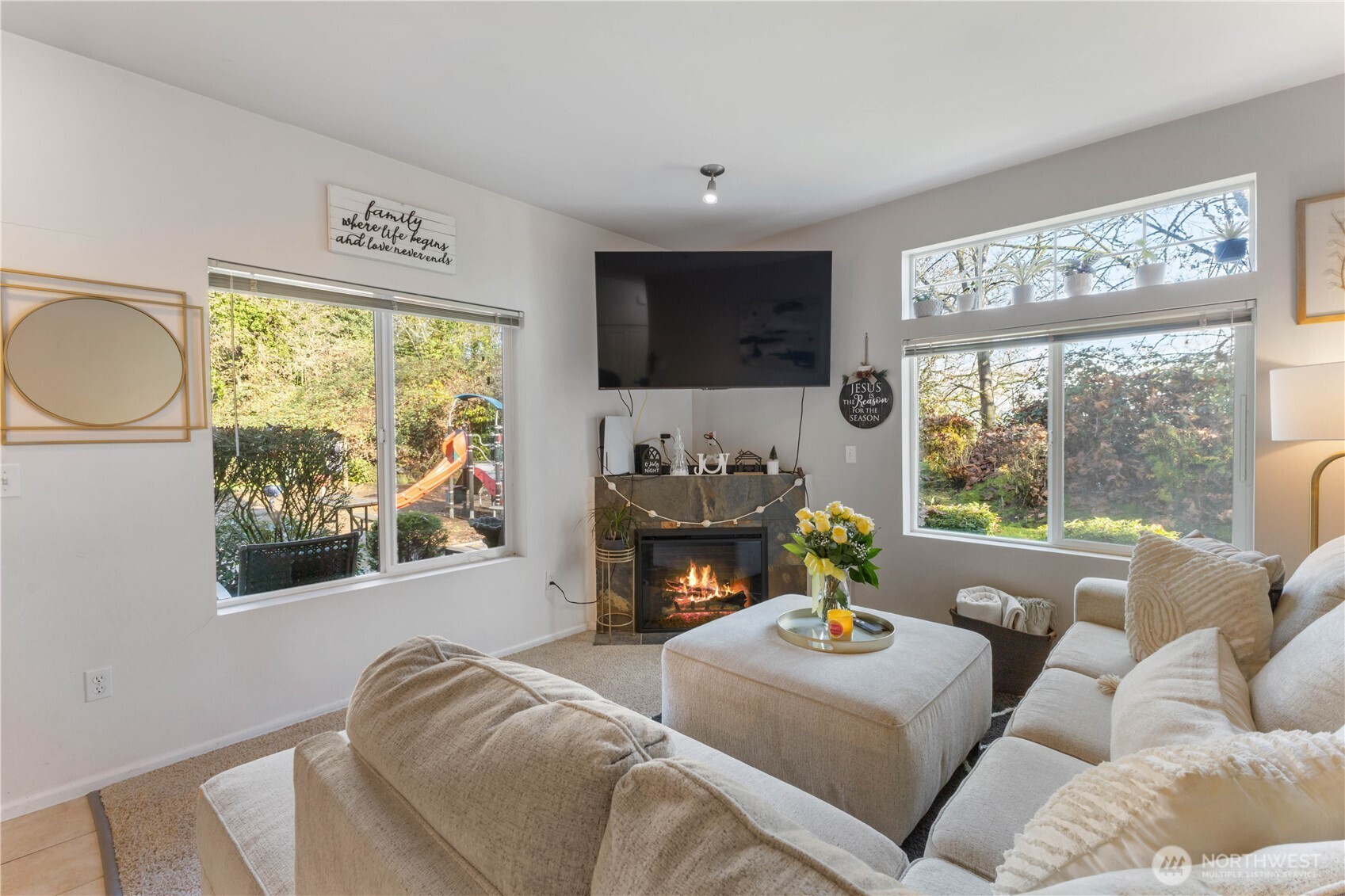 21430 40th Place South, Unit A Seattle, WA 98198 - Photo 7 of 27 a living room with furniture a fireplace and a large window