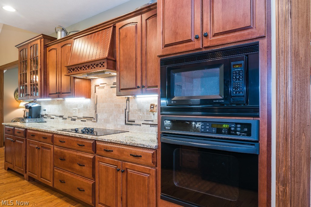 16277 Snyder Road Chagrin Falls, OH 44022 - Photo 14 of 35 Cherry cabinets and newer granite countertops, backsplash, plumbing fixtures and undermount lighting