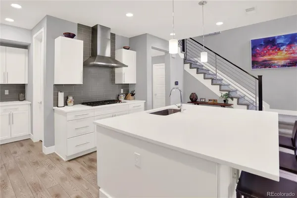 a kitchen with a sink a stove and a refrigerator
