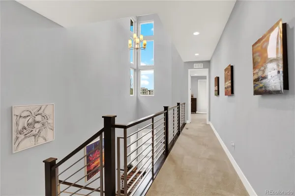 a view of a hallway with wooden floor and windows