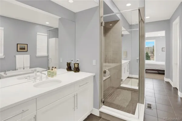 a bathroom with a sink a mirror and a shower