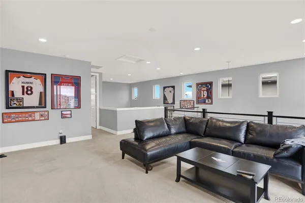 a living room with furniture and wall paintings