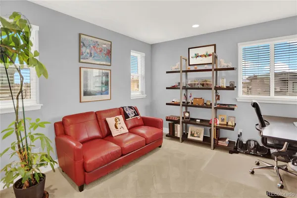 a living room with furniture workspace and a window