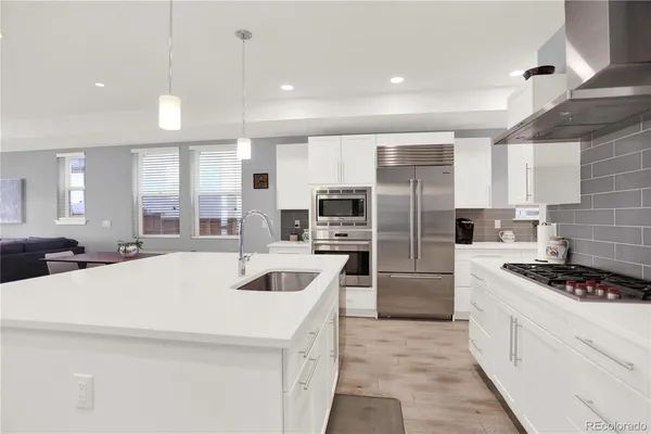 a kitchen with stainless steel appliances a refrigerator sink and stove