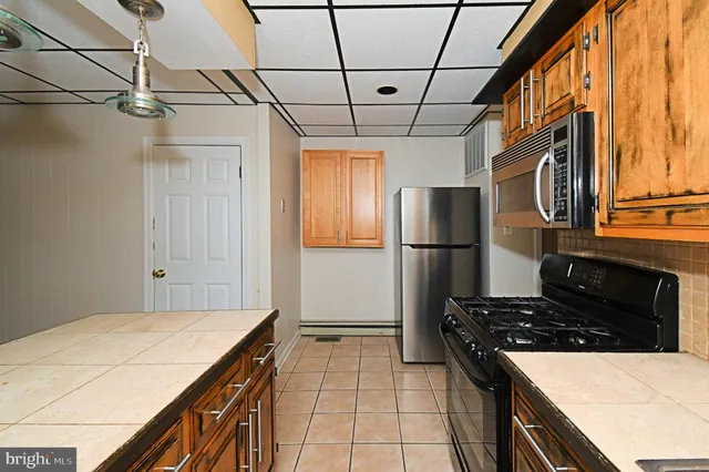 a kitchen with a stove and a refrigerator