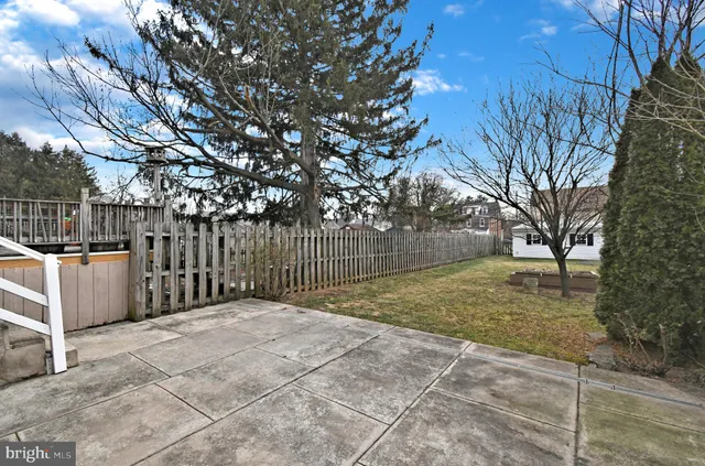 a view of a house with wooden fence