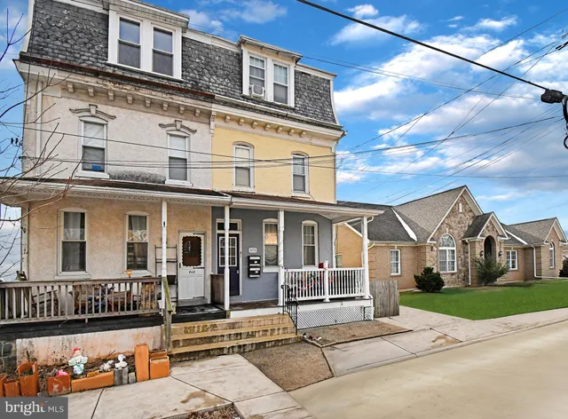 a view of a white building among the street side