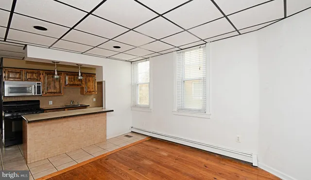 a kitchen with stainless steel appliances granite countertop a sink and a microwave