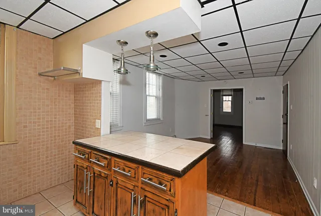 a view of a hallway with a dining table and chairs