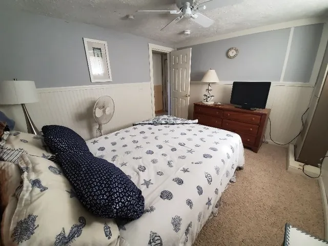 a bedroom with bed and a night stand