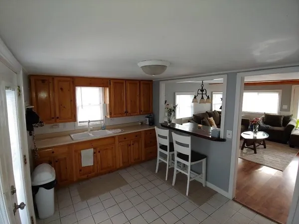 a kitchen with granite countertop lots of counter top space dining table and chairs