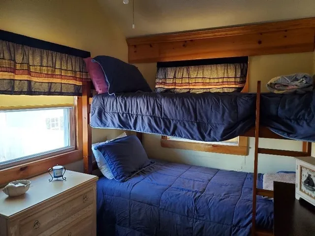 a bed sitting in a bedroom next to a window