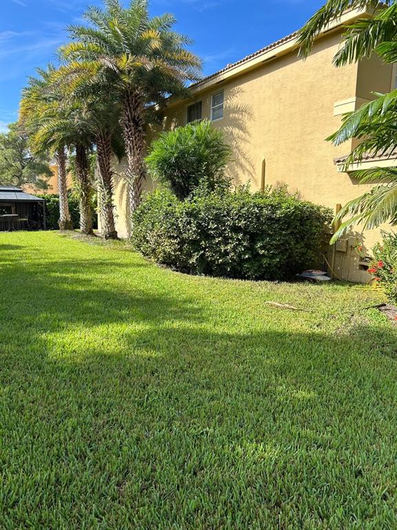 13118 Southwest 45th Drive Miramar, FL 33027 - Photo 11 of 13 a view of a trees front of house with a yard