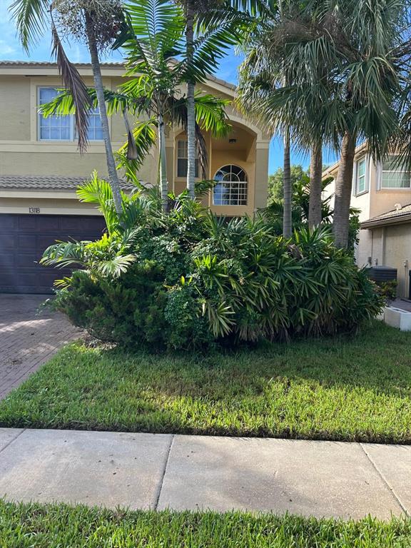 13118 Southwest 45th Drive Miramar, FL 33027 - Photo 12 of 13 a front view of a house with a yard