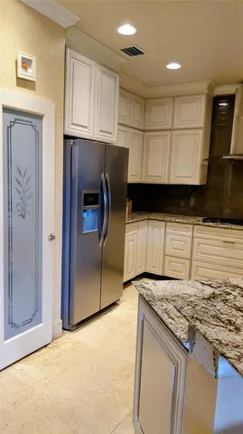 a kitchen with granite countertop a sink stainless steel appliances and cabinets