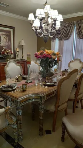 a view of a dining room with furniture and chandelier