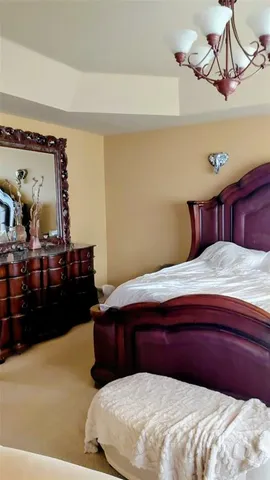 a bedroom with a bed and a dresser