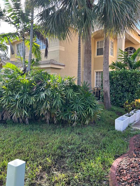 13118 Southwest 45th Drive Miramar, FL 33027 - Photo 10 of 13 a front view of a house with a garden