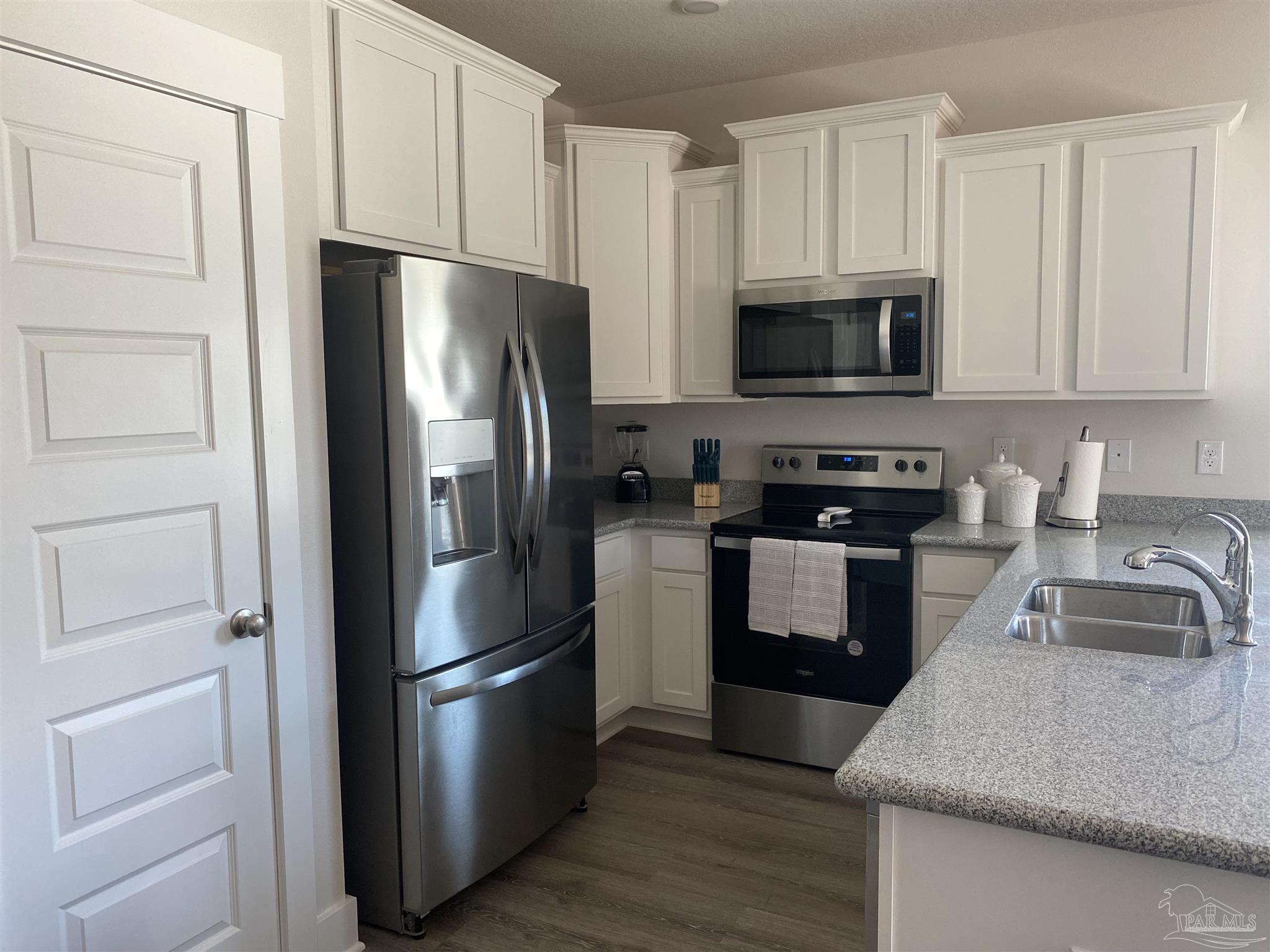 9613 Nature Creek Boulevard Pensacola, FL 32526 - Photo 2 of 10 a kitchen with a refrigerator sink and microwave