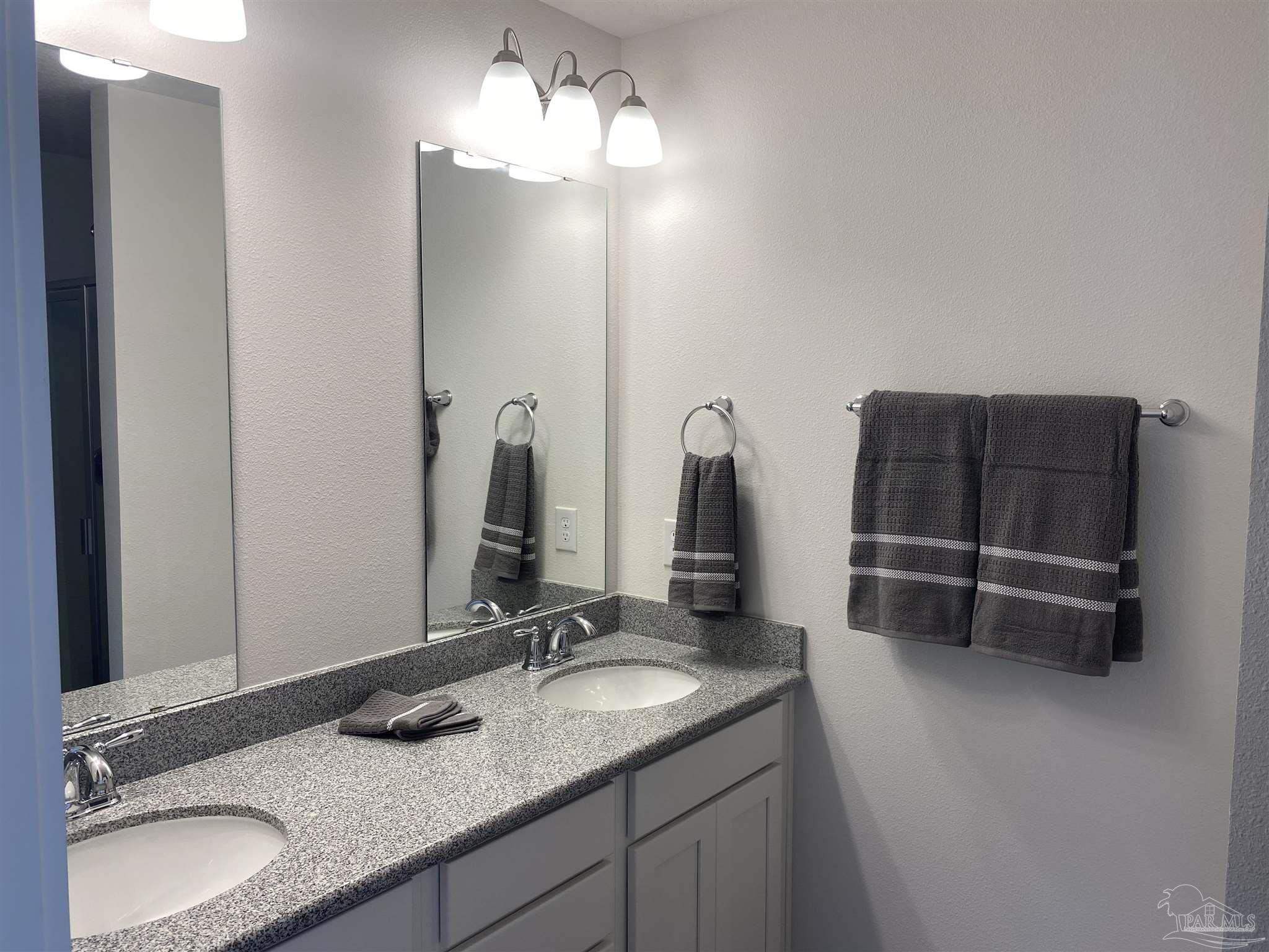 9613 Nature Creek Boulevard Pensacola, FL 32526 - Photo 7 of 10 a bathroom with a granite countertop sink and a mirror