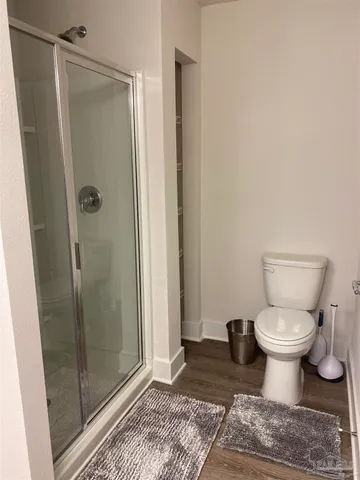 a bathroom with a toilet and a shower