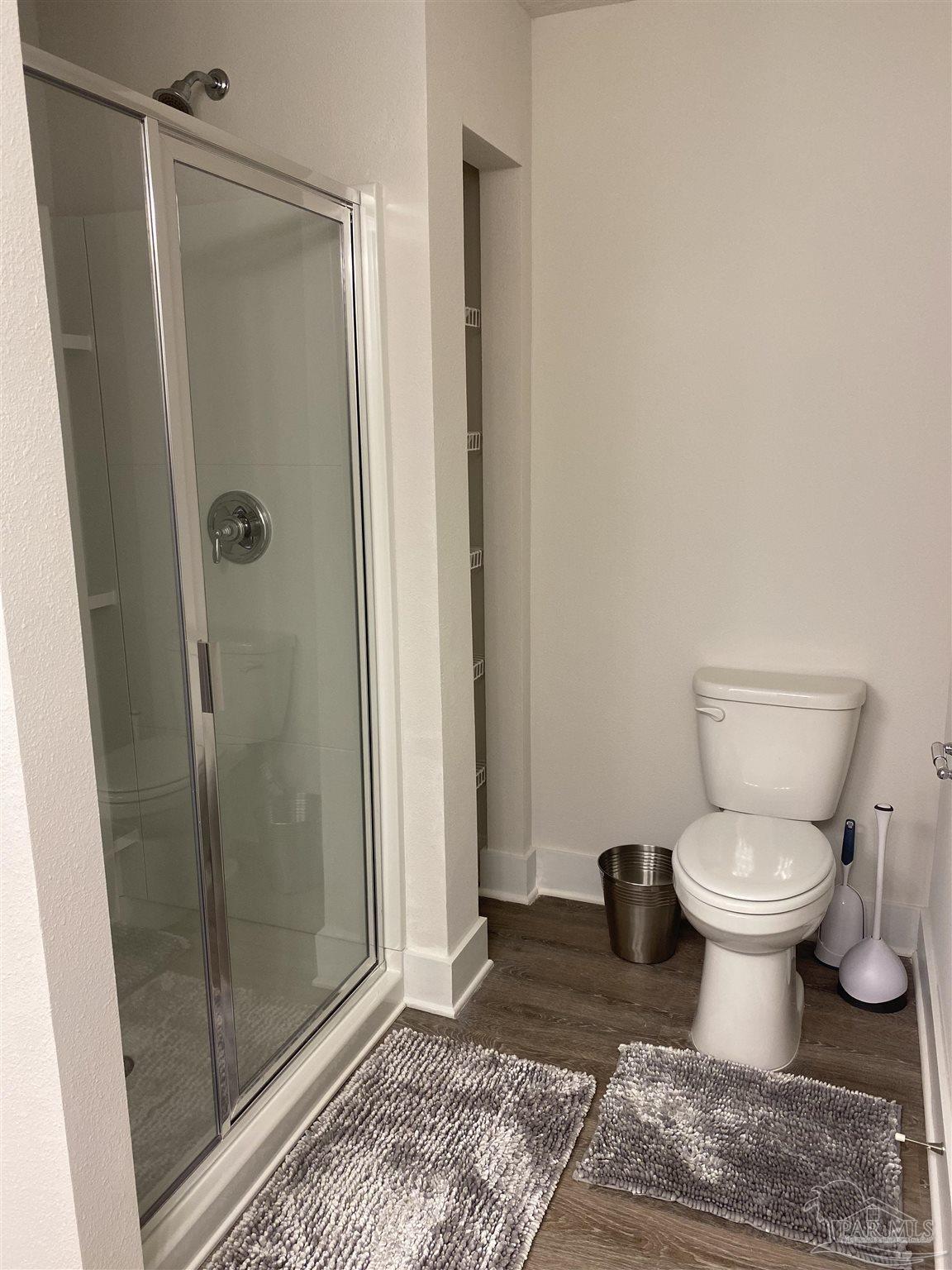 9613 Nature Creek Boulevard Pensacola, FL 32526 - Photo 8 of 10 a bathroom with a toilet and a shower