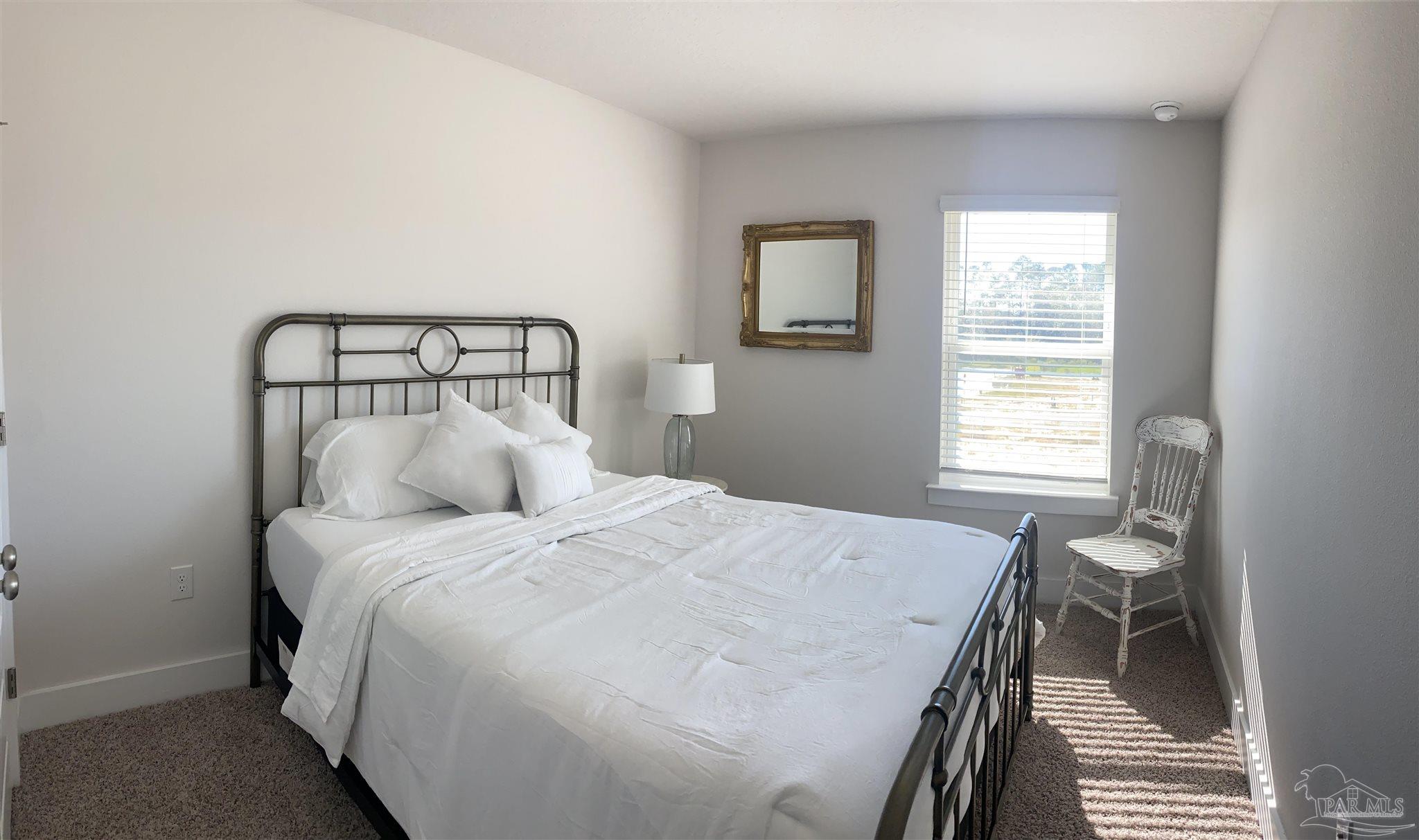 9613 Nature Creek Boulevard Pensacola, FL 32526 - Photo 10 of 10 a bedroom with a bed and a window