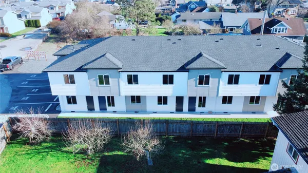 an aerial view of a house with a yard and lake view