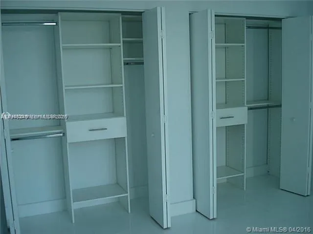 a kitchen with a refrigerator and cabinets